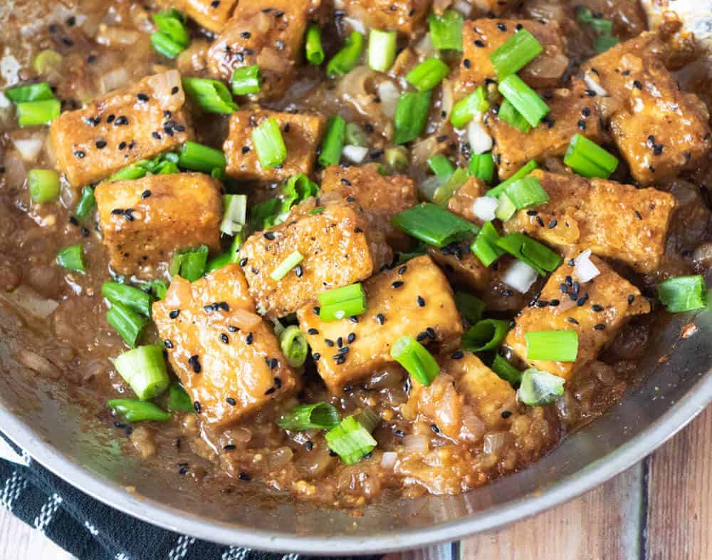 overhead shot of garlic ginger tofu stir fry with garlic ginger and scallions