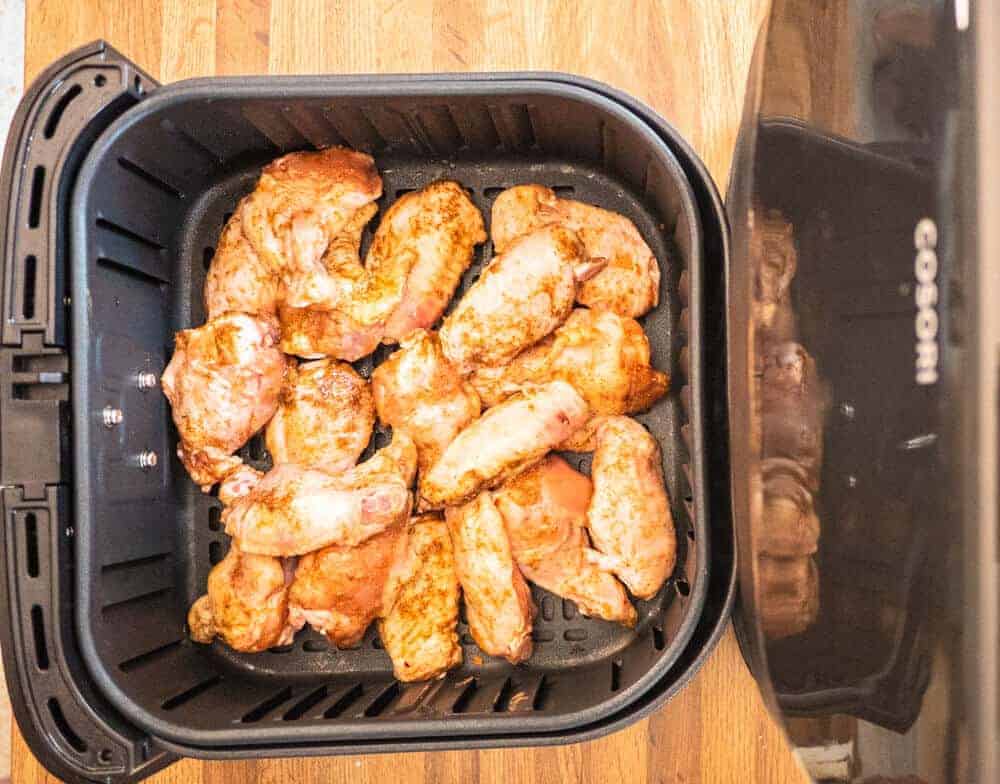 Seasoned Jerk Wings in Air Fryer Basket Raw