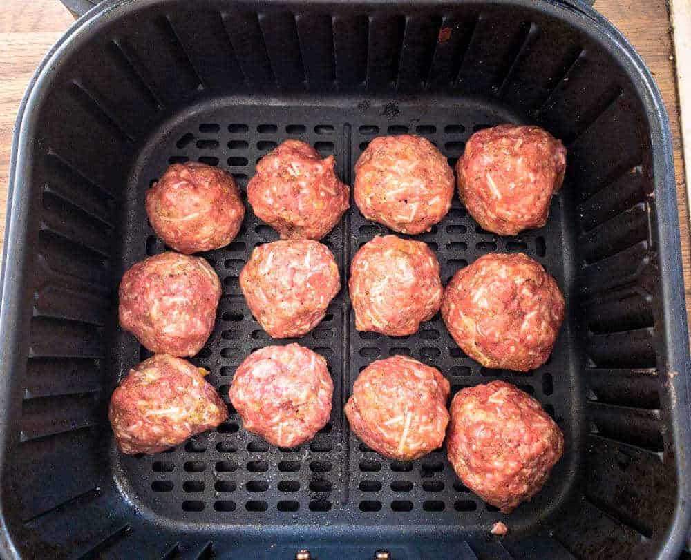 Meatballs in Air Fryer Basket ready to cook.