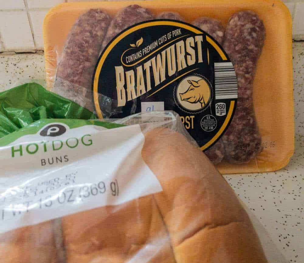 raw bratwurst and pack of buns to be smoked