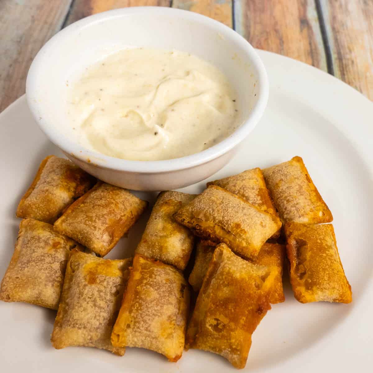 pizza rolls in air fryer ready to eat with garlic dipping sauce.