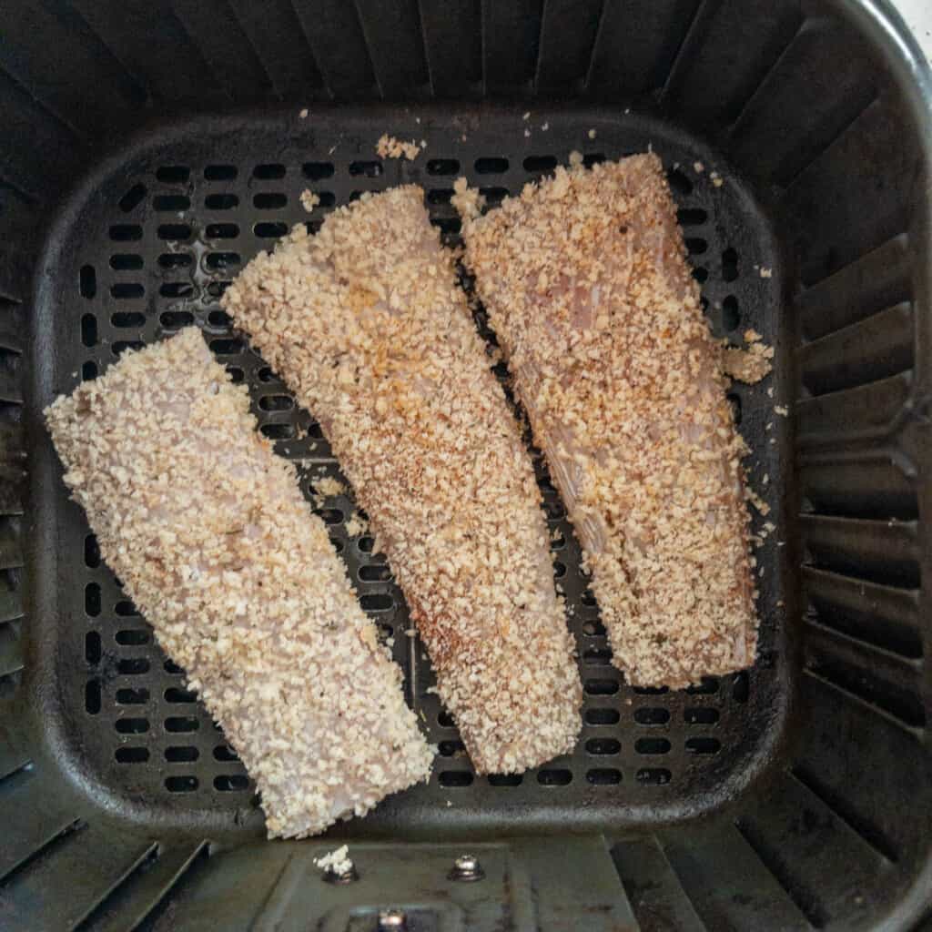 Air fryer mahi-mahi breaded and ready to cook in air fryer basket step 3