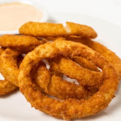 Frozen onion rings in the air fryer featured close up image