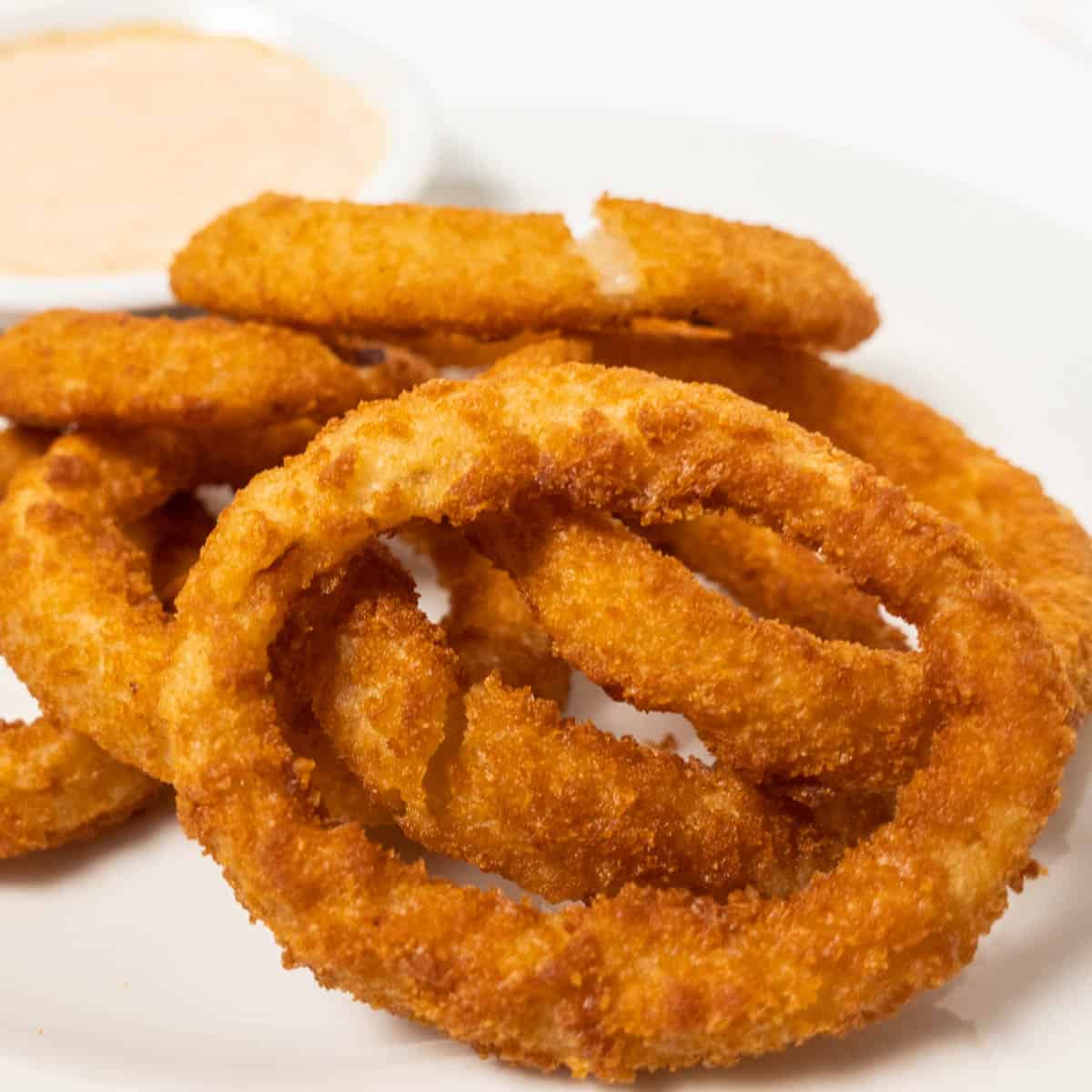 Frozen onion rings in the air fryer featured close up image