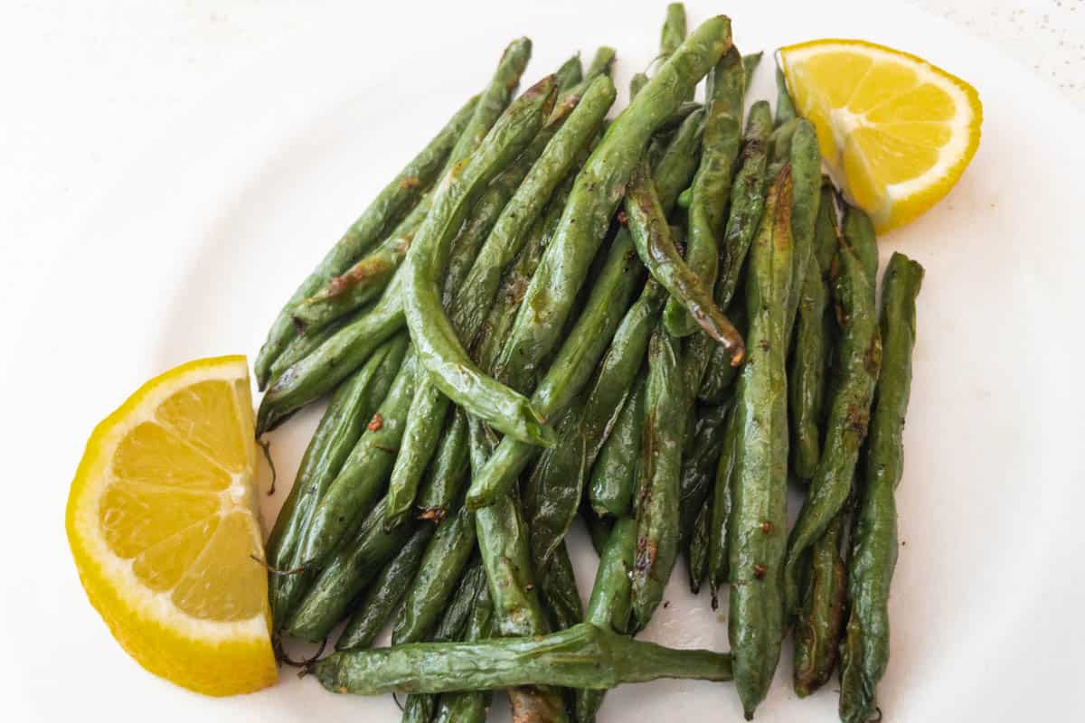 Air Fryer Green Beans in white dish with lemon slices