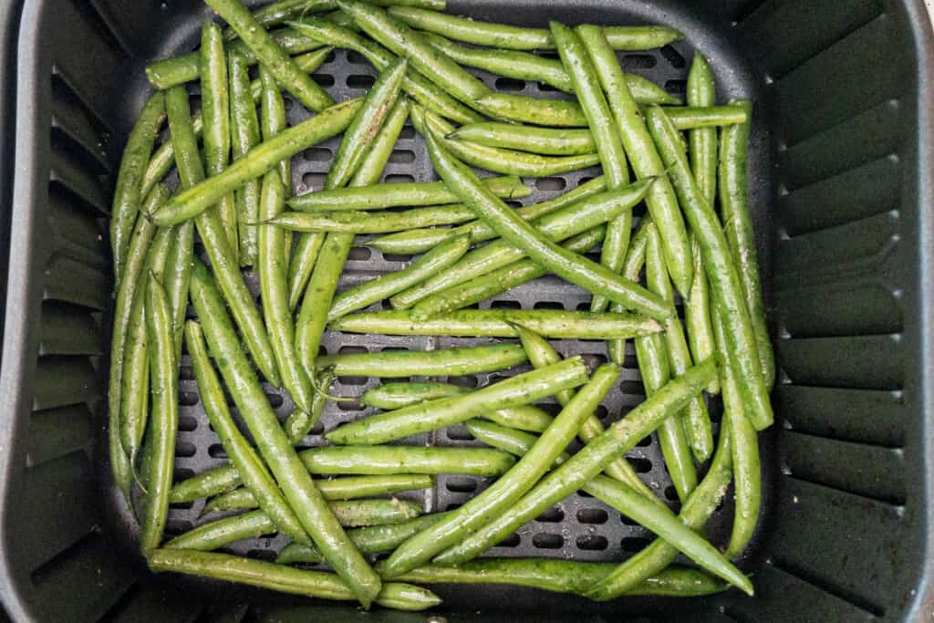 green beans in basket seasoned and sprayed with oil