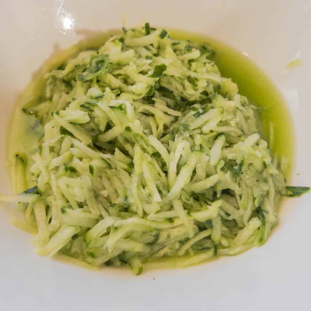 Step 2 Squeeze water out of salted grated cucumber