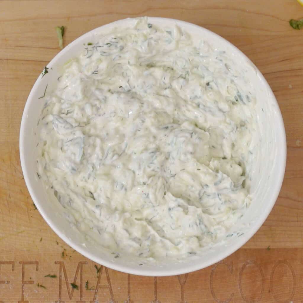 Step 3 - mix yogurt into drained grated cucumbers in a bowl