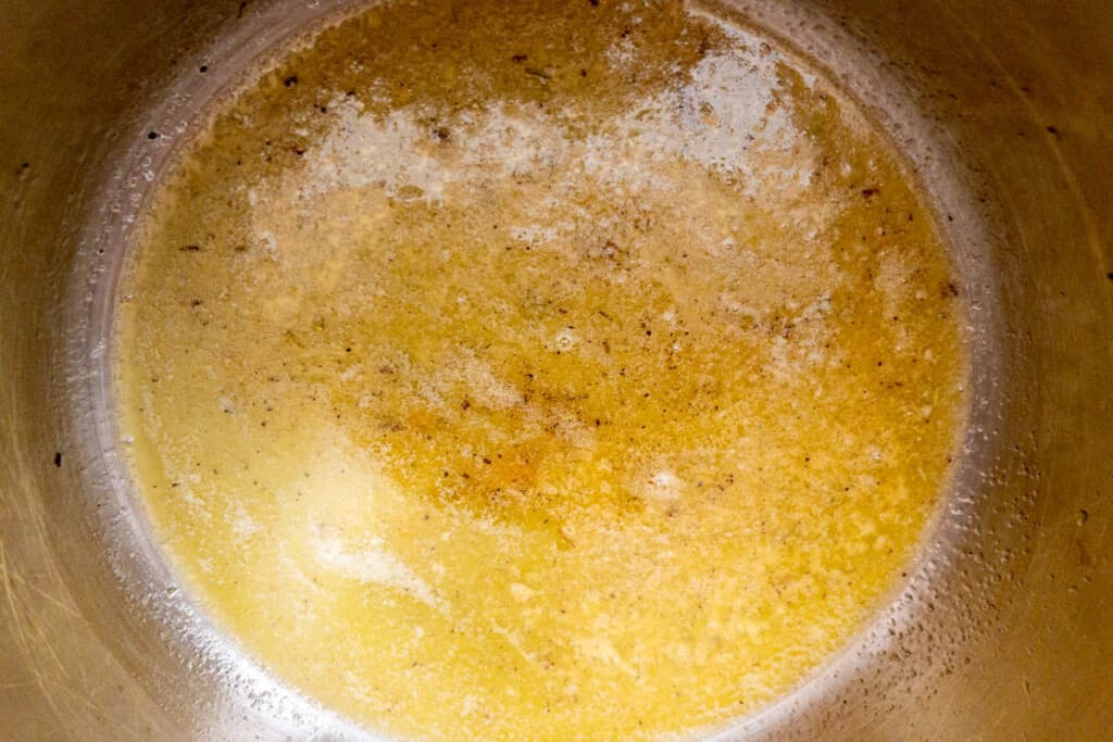 Butter and herbs melted and ready in liner for instant pot potatoes