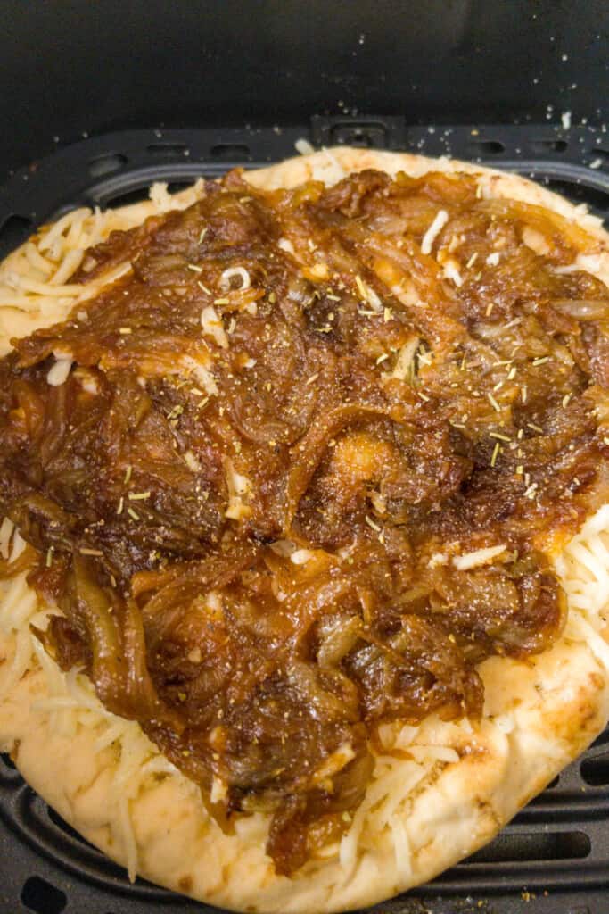 naan pizza preparation step 2 add caramelized onions
