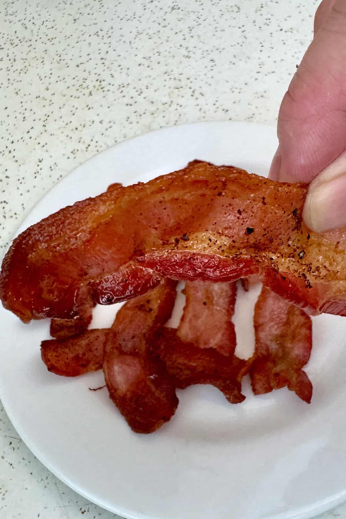 Close-up shot of crispy air fryer bacon showing its crunchy texture and deep golden color.