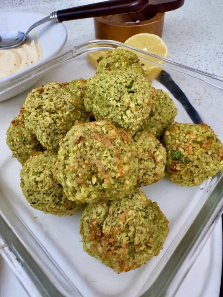 Close-up shot of crispy homemade falafel with fresh herbs.