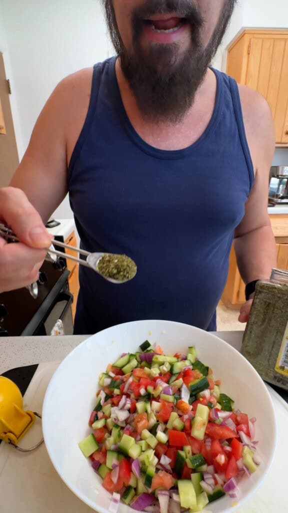 Adding dried mint to Shirazi salad