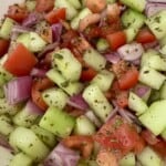 Close-up of homemade Shirazi salad with diced cucumbers, tomatoes, red onion, and dried mint