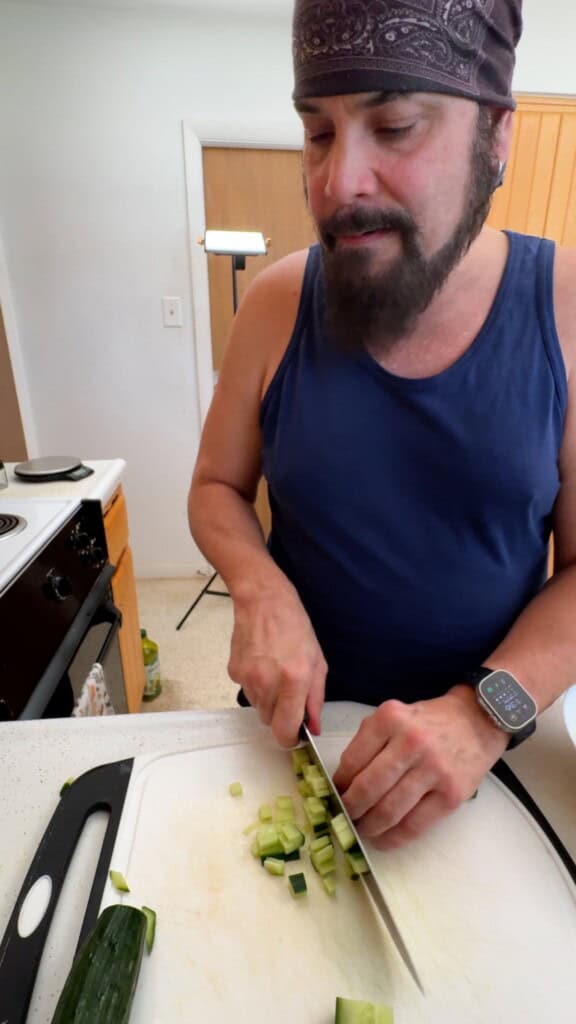 Dicing cucumber into small pieces for Shirazi salad