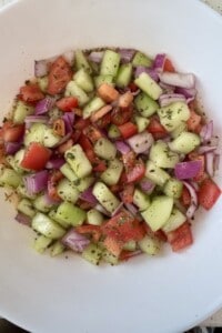 Homemade Shirazi salad made with diced cucumbers, tomatoes, red onion, dried mint, olive oil, and fresh lime juice